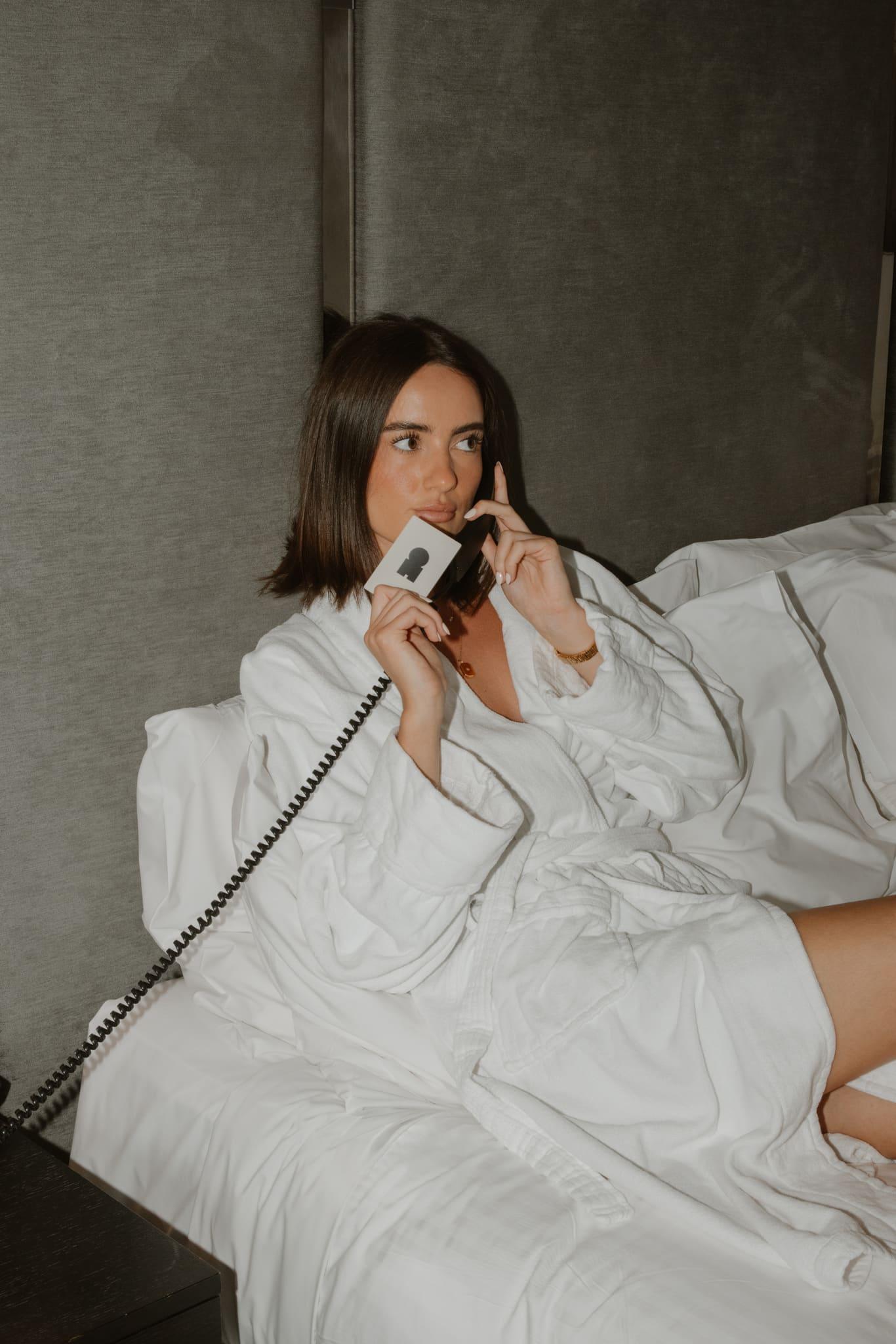 A creator holding a Marlo card while speaking on the phone