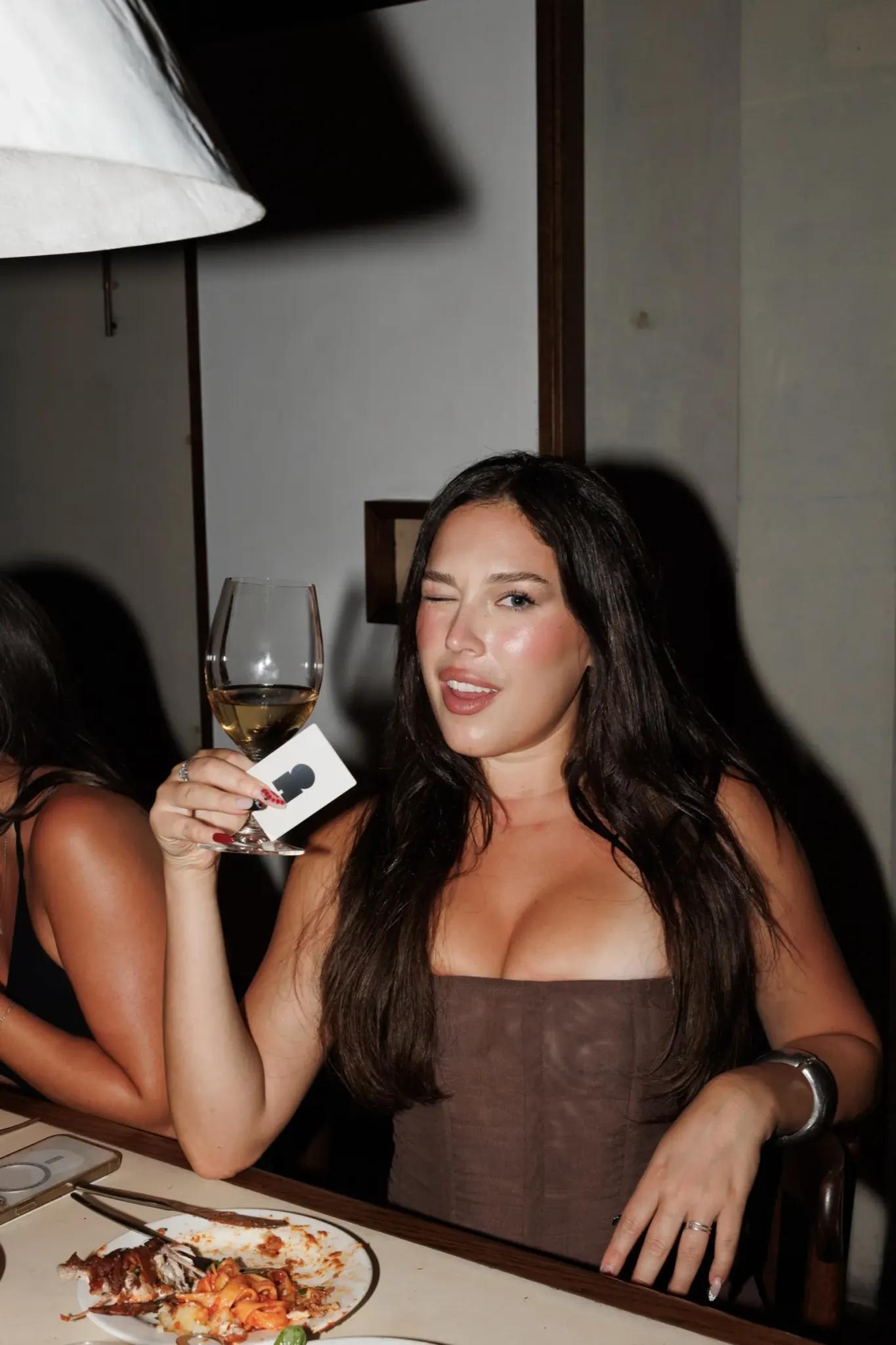 A guest at the table holding a Marlo card